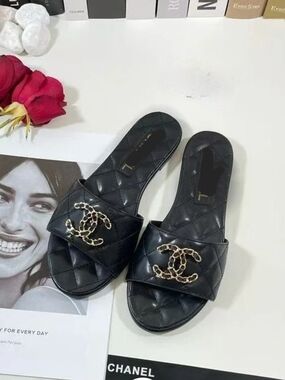 Black Quilted Slide Mules with Gold Chain Emblem